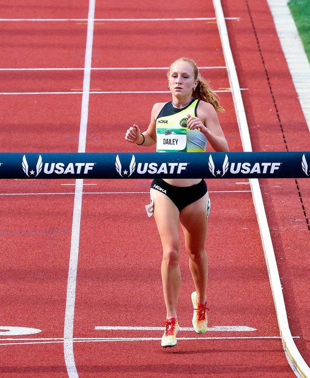 High school track athlete crossing the finish line